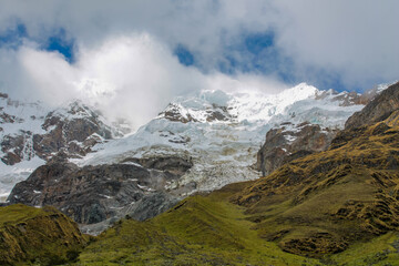 Salkantay mountain and lake on a trek to Machu Picchu in the Andes, Peru. Peruvian trekking and hiking in the Andes mountain, Salkantay summit glacier snow and ice above green valley