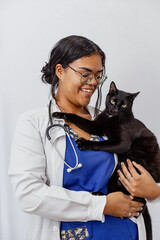 Portrait Of Happy Veterinarian Doctor Woman Holding A black pet, Posing With Healthy Patient Over Gray Studio Background, Smiling At Camera. Pet Health Care And Routine Check Up Concept, 