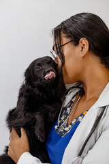 Portrait Of Happy Veterinarian Doctor Woman Holding A black pet, Posing With Healthy Patient Over...