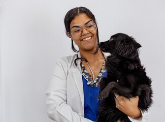 Portrait Of Happy Veterinarian Doctor Woman Holding A black pet, Posing With Healthy Patient Over...