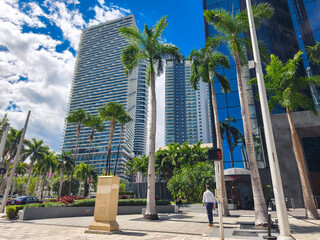 Miami, Florida - Feb 27, 2025: Street-level view of the SLS Brickell luxury high-rise framed by palm trees and city buildings in downtown Miami.