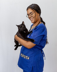 Portrait Of Happy Veterinarian Doctor Woman Holding A black pet, Posing With Healthy Patient Over...