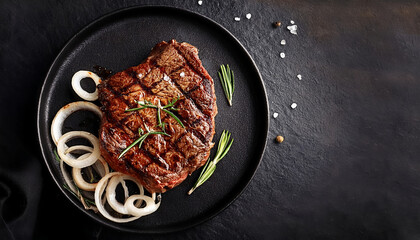 Delicious Grilled Steak on Black Plate with Caramelized Onions and Rosemary