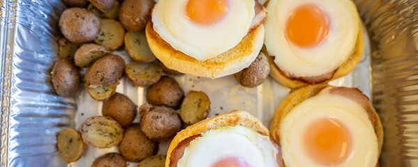 Eggs Benedicts with grilled potatoes for breakfast