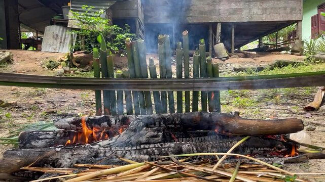 The process of burning lemang, a typical Indonesian food