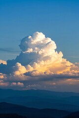 there is a large cloud that is in the sky over the mountains