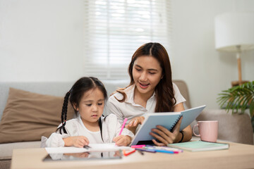 Creative Learning and Mother-Daughter Time. A mother shares a joyful moment with her child during study time.