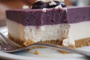 Tasty layered dessert with blueberry topping served at a cafe