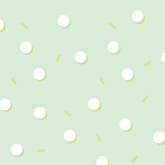 Seamless pastel green background with white polka dots and yellow dashes. Minimalist and modern pattern perfect for kids products, wallpapers, fabric, wrapping paper, and branding