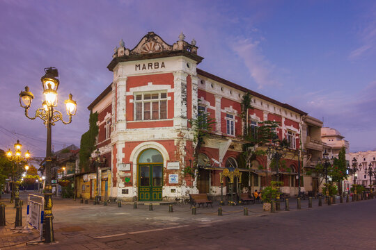 Semarang - Indonesia, April 5, 2025 : View of The Marba Building in Kota Lama Semarang, stands prominently at dawn. Its historic architecture, featuring red brick and white accents.