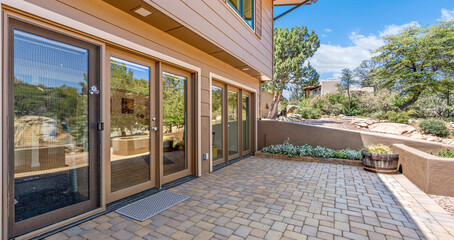 A spacious house with a patio and sliding glass doors for access