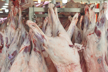 Fresh lamb carcasses hanging in market display for customers © Towfiqu Barbhuiya 