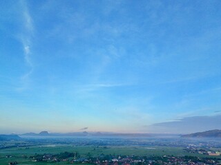 Aerial photography of rural settlement rice field scenery, sunrise in the morning with beautiful dew mist