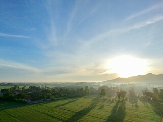 Aerial photography of rural settlement rice field scenery, sunrise in the morning with beautiful...