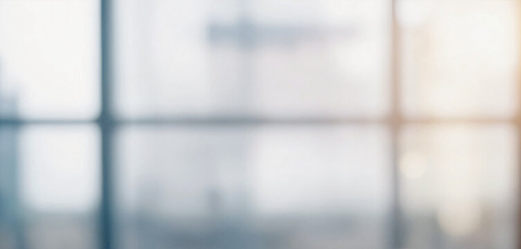 Blurry image depicting an out of focus view through an office window, suggesting a modern and professional setting.