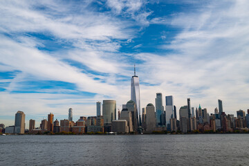 Obraz premium New York City cloudy skyline. NYC skyscrapers. Manhattan. NY cityscape with clouds. Downtown New York buildings. NYC skyline. New York harbor view. Skyscrapers in Manhattan. NYC downtown.