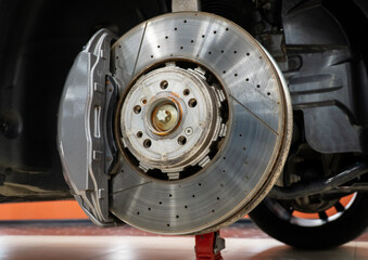 Car ventilated front brake disc with caliper. Modern brake disc with ventilation holes and cooling....