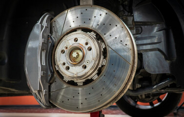 Car ventilated front brake disc with caliper. Modern brake disc with ventilation holes and cooling....