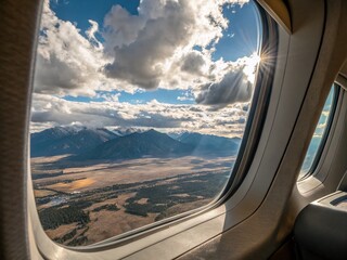 Fototapeta premium Airplane Cabin Window Landscape View: Stunning Aerial Scenery from Airplane Seat