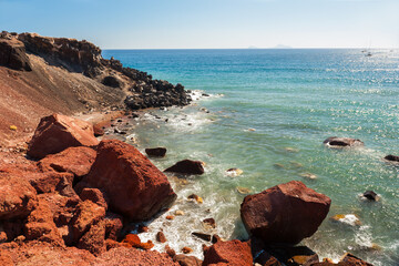 Red beach in Santorini island, Greece. Red volcanic rocks and the blue sea.