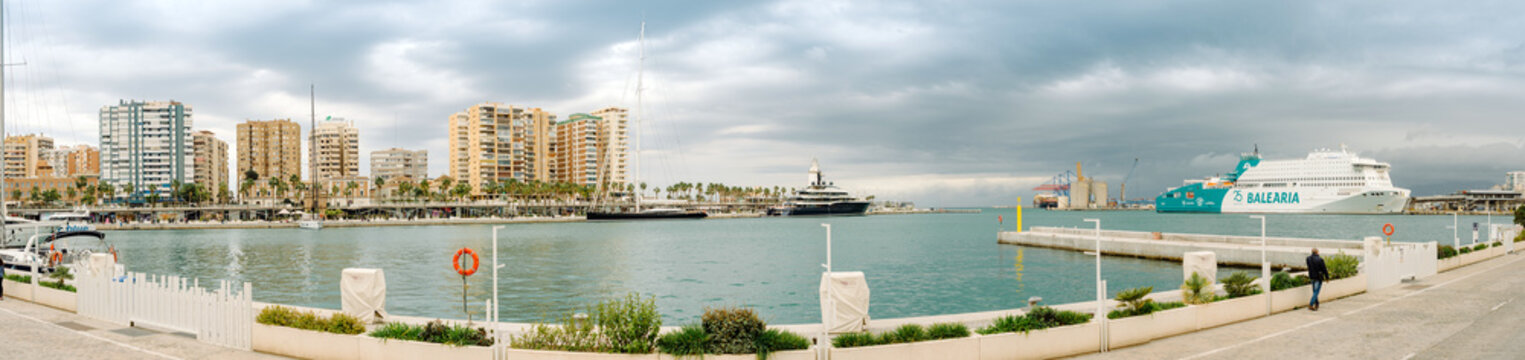 Malaga, Spain - February 28, 2025: Panorama of Malaga port with passenger ferry