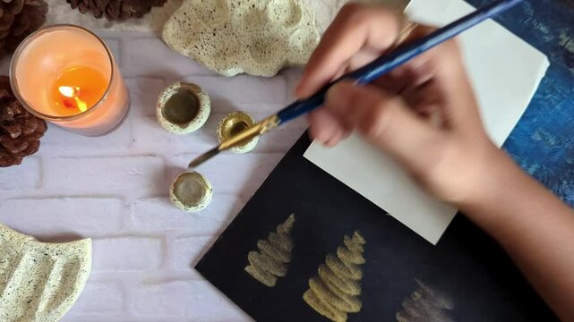 Handmade watercolor paints in shells and palette with minimal background 