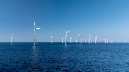 Spread across the calm waters, numerous windmill turbines stand tall, harnessing sustainable...