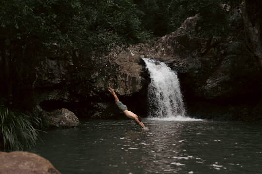 Man jumping into a waterfall