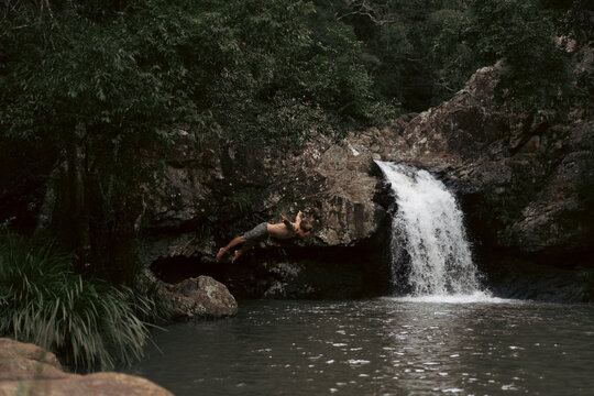 Man jumping into a waterfall