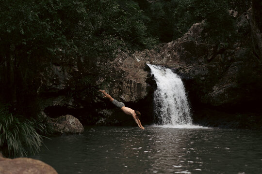 Man jumping into a waterfall