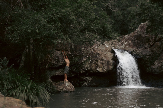 Man jumping into a waterfall