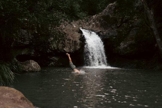 Man jumping into a waterfall