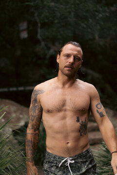 Wet man after jumping into a waterfall