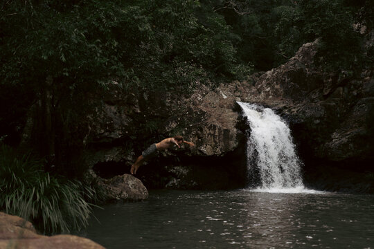 Man jumping into a waterfall