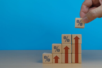 Selling Price and Taxes Concept, Wooden Blocks with Percent Sign and Up Arrow