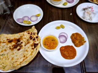a traditional Indian meal, likely a Thali, which is a platter featuring a variety of dishes served together. 