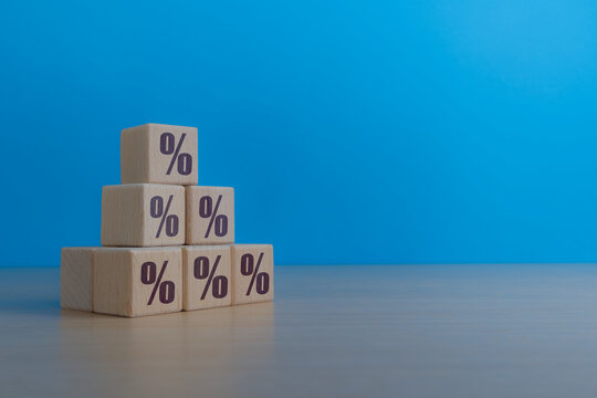 Increase interest rate or tax, percentage icon on increasing wooden block
