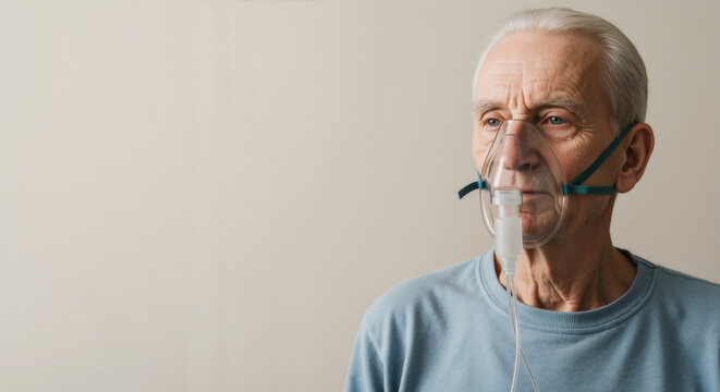 Senior man with oxygen mask against neutral background. Medical respiratory support equipment for elderly care and pulmonary disease treatment
