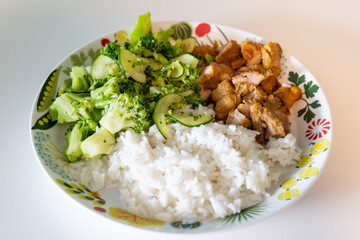 rice, chiken and broccoli on a plate. healthy food and diet concept