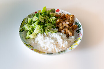rice, chiken and broccoli on a plate. healthy food and diet concept