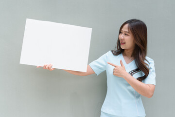 young woman nurse holding blank board