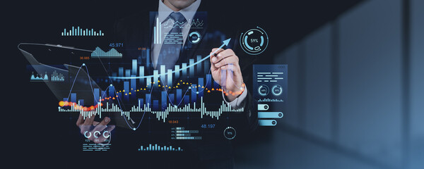 Obraz premium Businessman analyzing financial data with futuristic digital interface.