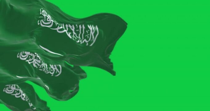 Saudi Arabian flags waving in the wind with national emblem and green field