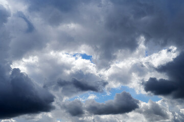 Cloudy pre-storm sky. Dark and white clouds on a background of blue sky
