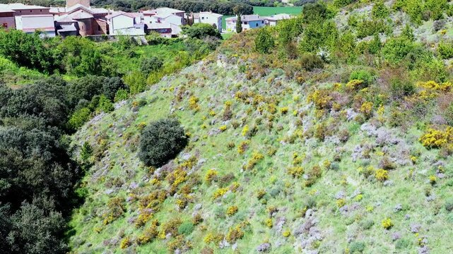 Aerial view revealing green hills, lush vegetation, and picturesque spanish landscape
