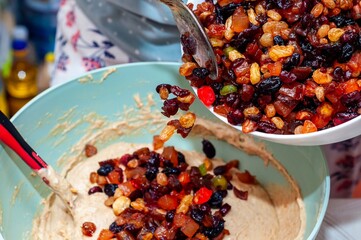 A vibrant image shows the process of baking a cake, adding dried fruits to the batter.