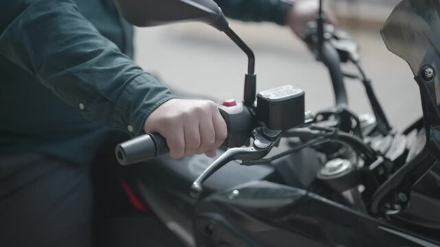 Close-up shot of biker hand twisting motorbike throttle. High quality FullHD footage