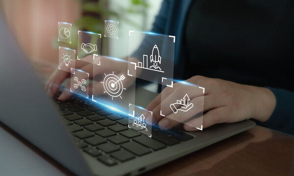 Business strategy concept. Using laptop with the icon representing business strategy elements; teamwork, partnership, innovation and technology, target and growth. Business goal acheivement.
