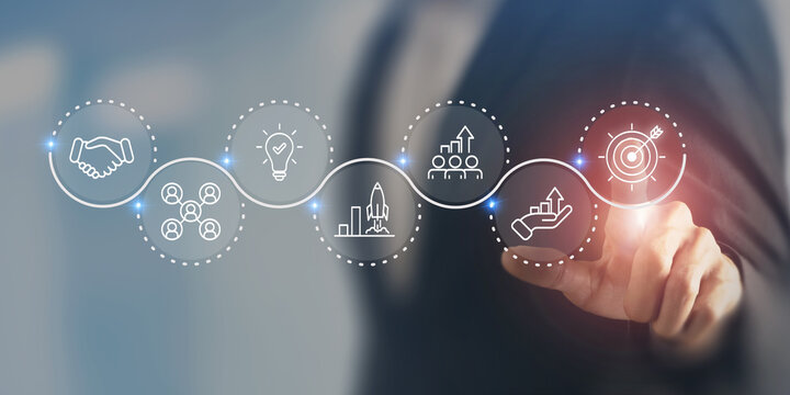 Business strategy concept. Touching screen on the icon representing business strategy elements; teamwork, partnership, innovation and technology, target and growth. Business goal acheivement.