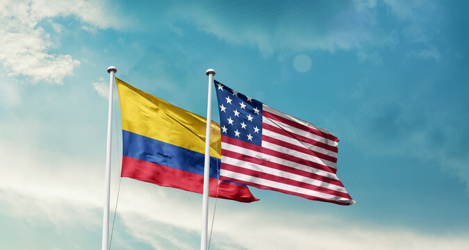 Colombia and America friendship flags are waving in the sky.Two country flag for agreement or deal. Colombia USA national flag for comittment.
